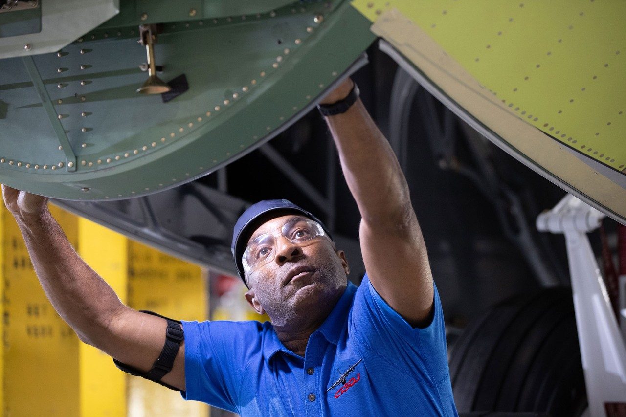 man looking at satellite model