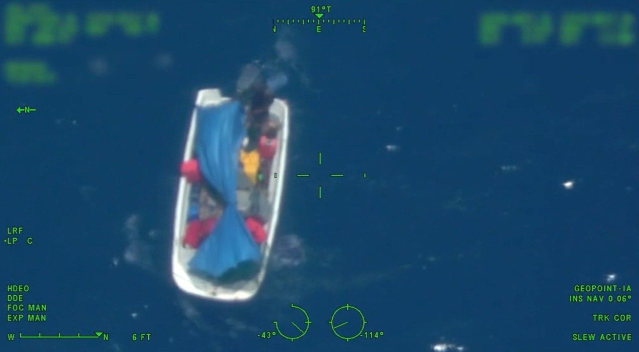 One of the two Bahamian men stranded aboard the disabled vessel waves an object to capture the attention of U.S. Coast Guard aircrews above. (Photo courtesy U.S. Coast Guard District 7).